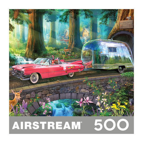A 500-piece jigsaw puzzle box featuring a whimsical forest scene with a red convertible car towing a silver trailer, surrounded by trees, flowers, and deer. The word 'AIRSTREAM' is printed at the bottom on a gray banner with '500' on the right.