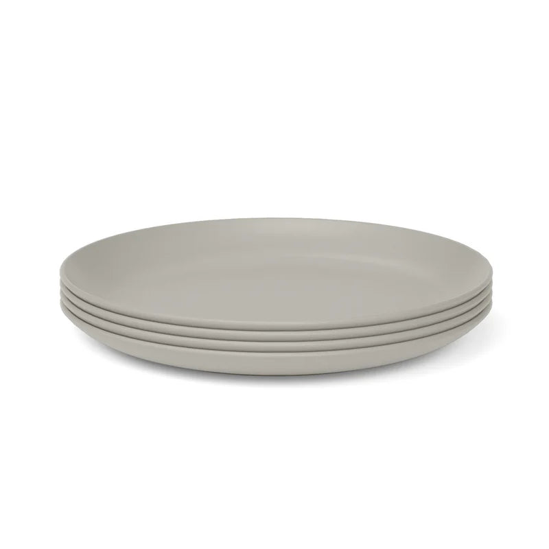 Four stacked, round, light gray dinner plates from the Bamboo Round Plate Set of 4 by Ekobo, crafted from eco-friendly bamboo composite, sit elegantly on a white background—offering a stylish and sustainable choice for reusable dining.