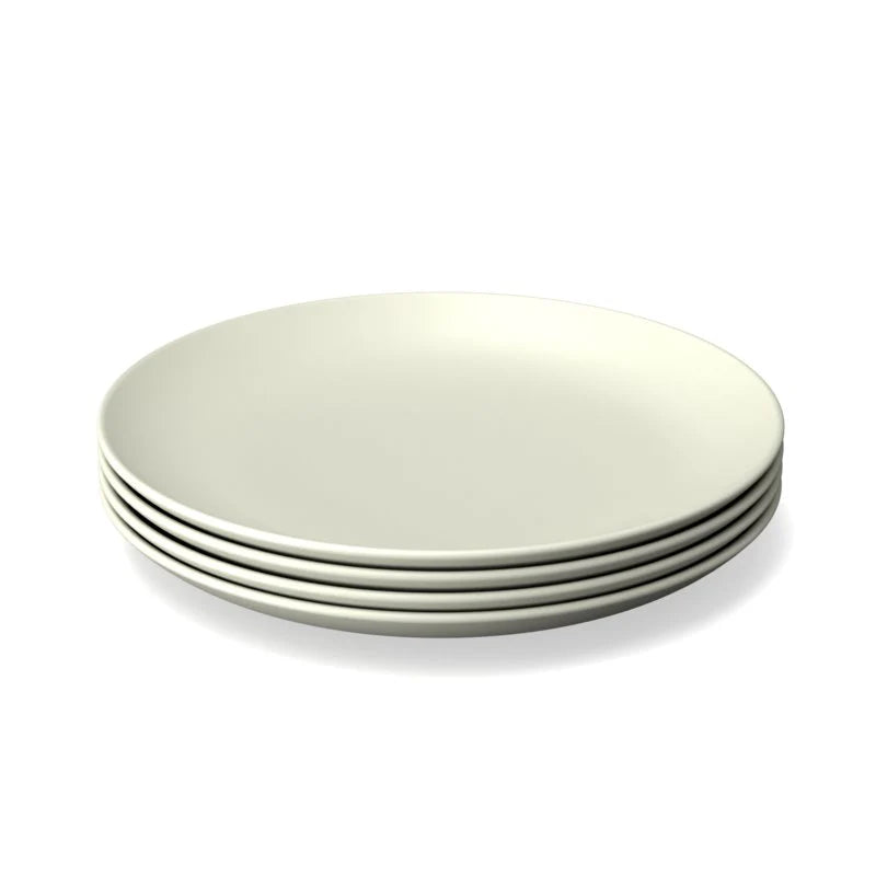 Four round bamboo plates from Ekobo’s set of four are stacked neatly on top of each other and displayed against a white background.