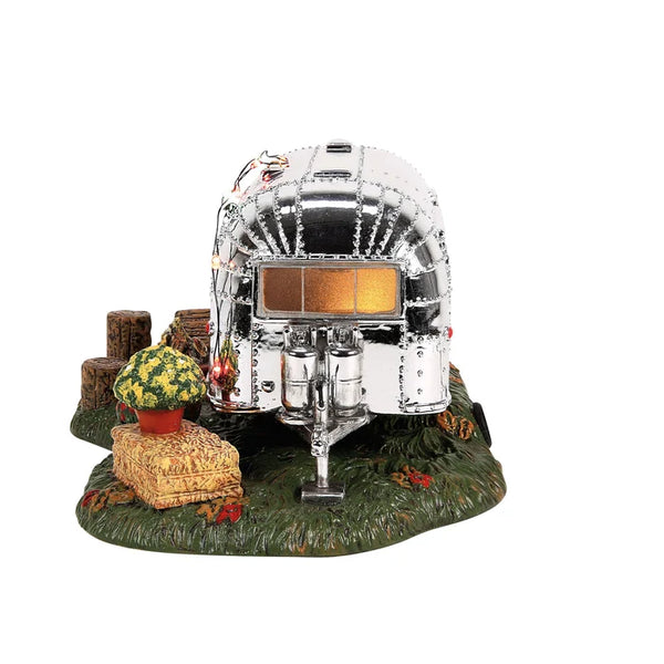 Model of a vintage camper with a solar panel on a white background