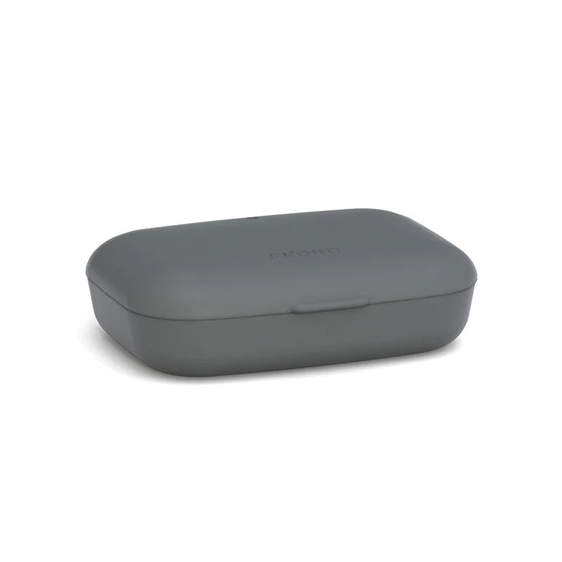 A closed, rectangular Bamboo Travel Soap Box by Ekobo, in matte gray with rounded edges and a small latch in front, is placed on a white background.