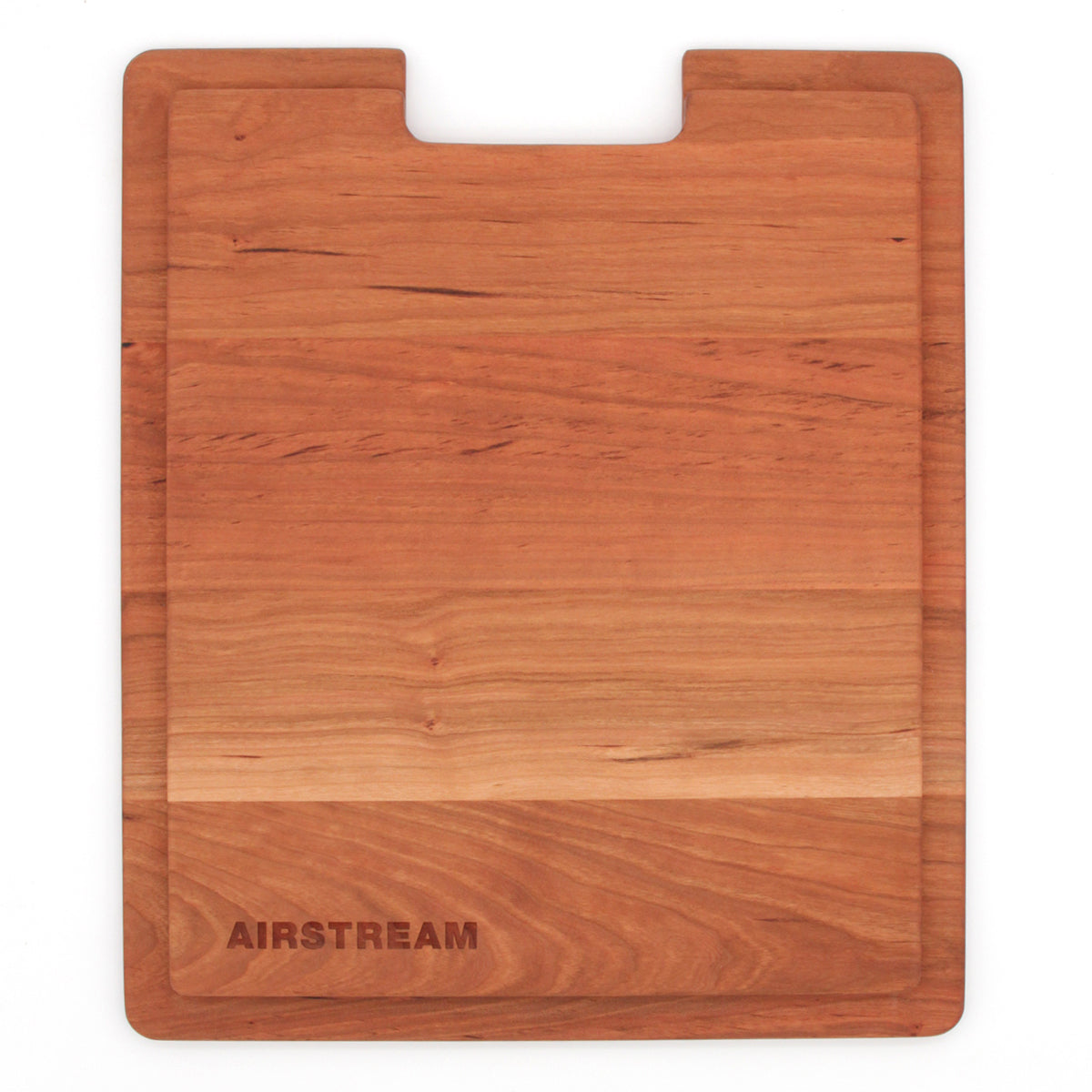 The Airstream Custom Sink Cutting Board for Interstate 24GT/GTX is a rectangular wooden board with a subtle groove around the edge and the word “AIRSTREAM” engraved in one corner, designed to fit your kitchen space perfectly while adding style and function.
