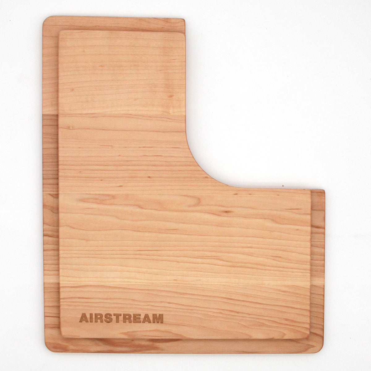 Airstream Custom Sink Cutting Boards for Interstate 24GT/GTX feature a rectangular wooden design with a curved cutout on one side, specifically crafted for Airstream sinks, and come engraved with the word “AIRSTREAM” in the lower left corner.