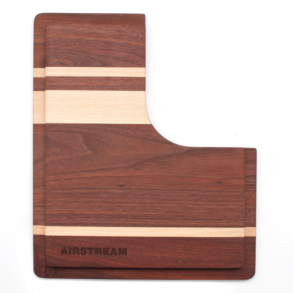 Airstream Custom Sink Cutting Board for Interstate 24GT/GTX—rectangular wooden board with an L-shaped cutout, featuring alternating light and dark wood stripes and “AIRSTREAM” engraved on the lower left corner. Precisely designed to fit over your Airstream sink, this custom cutting board adds both style and functionality to your kitchen setup.