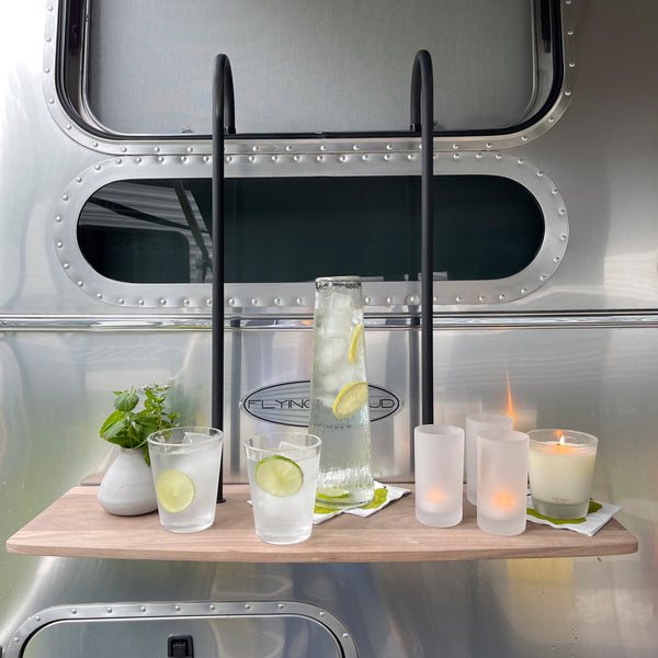 Table with drinks and candles in front of a metallic vehicle