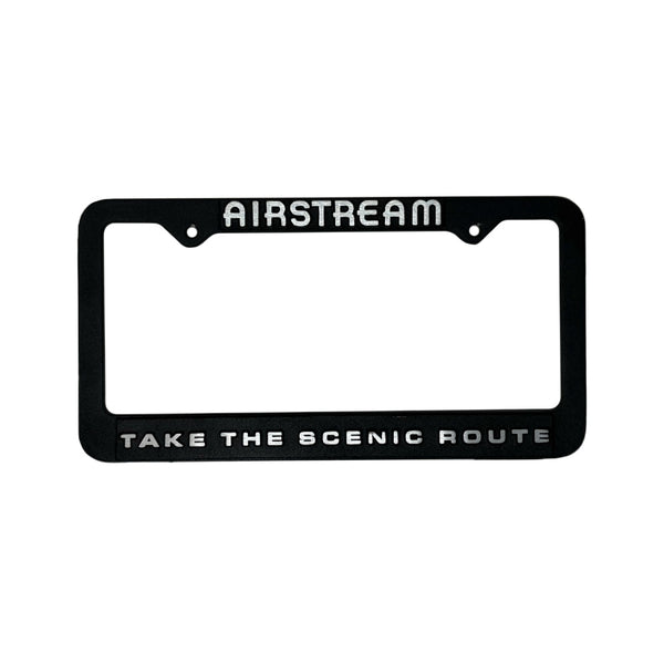 Black license plate frame with 'Airstream' and 'Take the Scenic Route' text on a white background