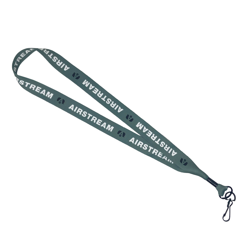 Airstream Pastel Lanyard in green with “AIRSTREAM” and small icons printed in white, finished with a black metal clip at the end.