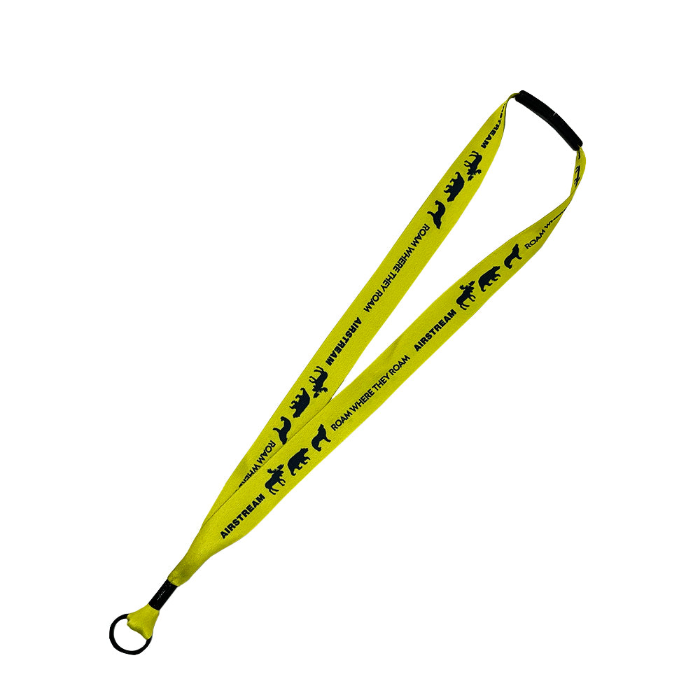 The Airstream Roam Where They Roam Lanyard is a yellow lanyard with black text and bear silhouettes, featuring a black plastic attachment and a metal key ring—perfect for those who love to explore.