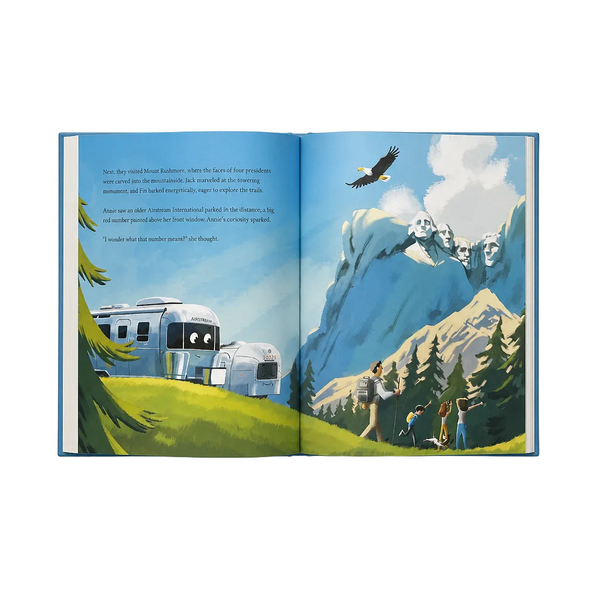 Open book showing a scenic illustration with mountains, a trailer, and people.