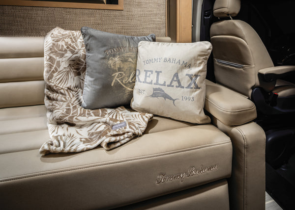 Tommy Bahama pillow and blanket on a leather couch