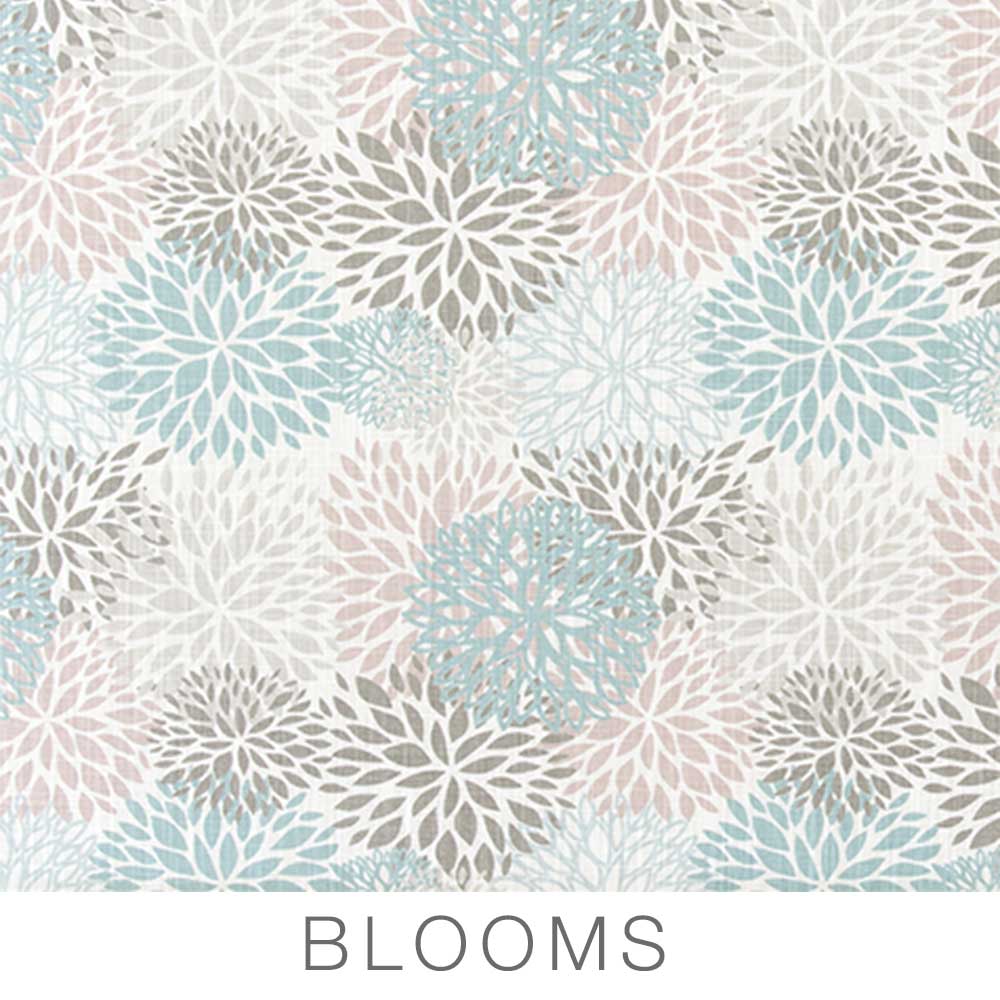 Featuring a pattern of overlapping floral shapes in blue, gray, and pale pink on a white background with the word BLOOMS printed below in gray, uppercase letters, the Airstream Printed Custom Curtains for Caravel Travel Trailers are the perfect way to add stylish flair to your Airstream Caravel. These custom replacement curtains offer an ideal blend of form and function for your travel trailer.