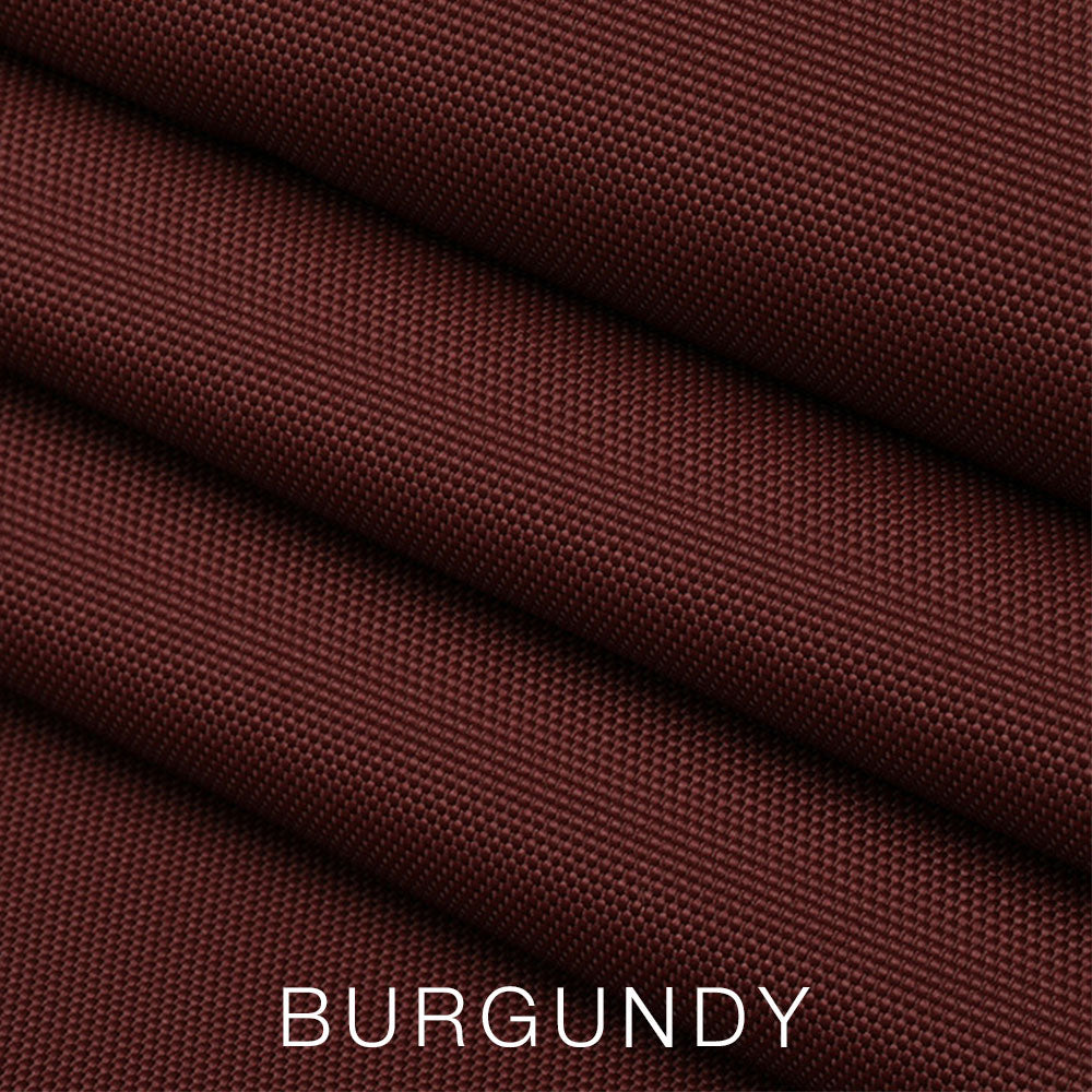 Four folds of burgundy-colored textured fabric are shown up close, evoking the luxurious feel of the Airstream Travel Trailer Padded Solar Window Guard Protector. The word BURGUNDY appears in white capital letters at the bottom of the image, suggesting sophisticated protection that would complement any Airstream interior. #color_Burgundy