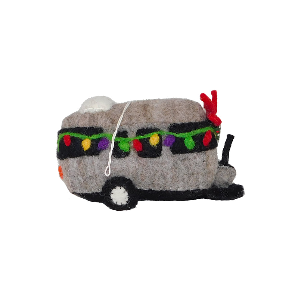 The Airstream Plush Trailer Ornament, crafted from felted wool and featuring colorful holiday lights, a red bow, and black wheels, makes the perfect eco-friendly holiday decoration against a white background.