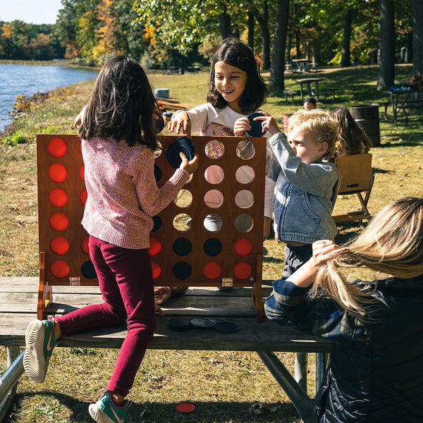 Children Playing With Elakai Giant 4-In-A-Row Game Outside