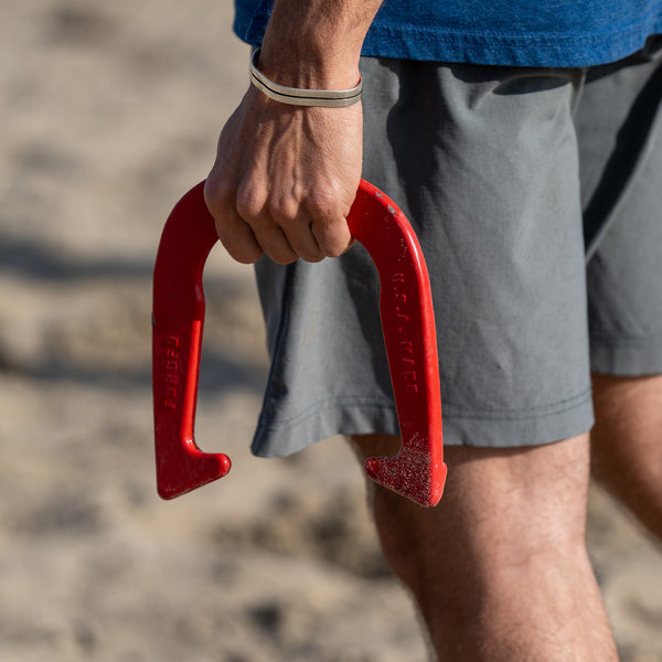 Man Holding Red Elakai Horseshoe