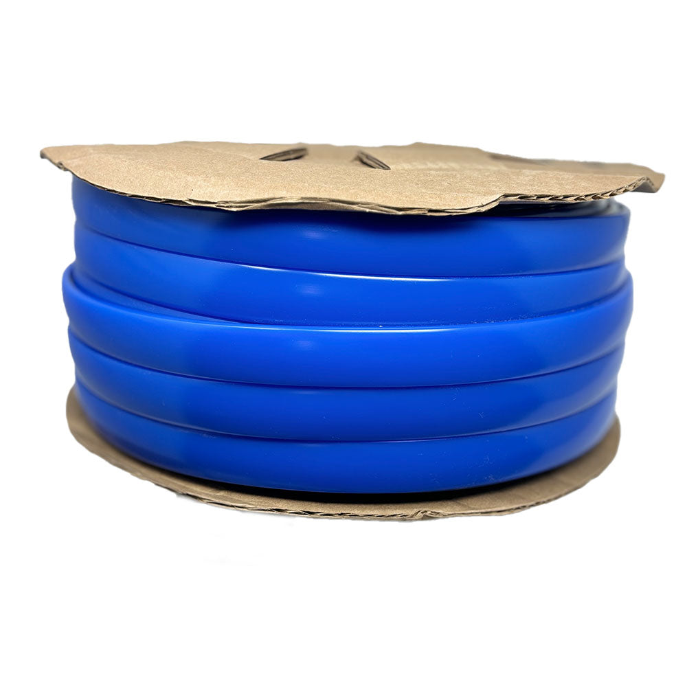 A coil of blue plastic tubing, designed as the Airstream Premium Replacement Rub Rail for Travel Trailers, is neatly wound on a round cardboard spool for easy installation.