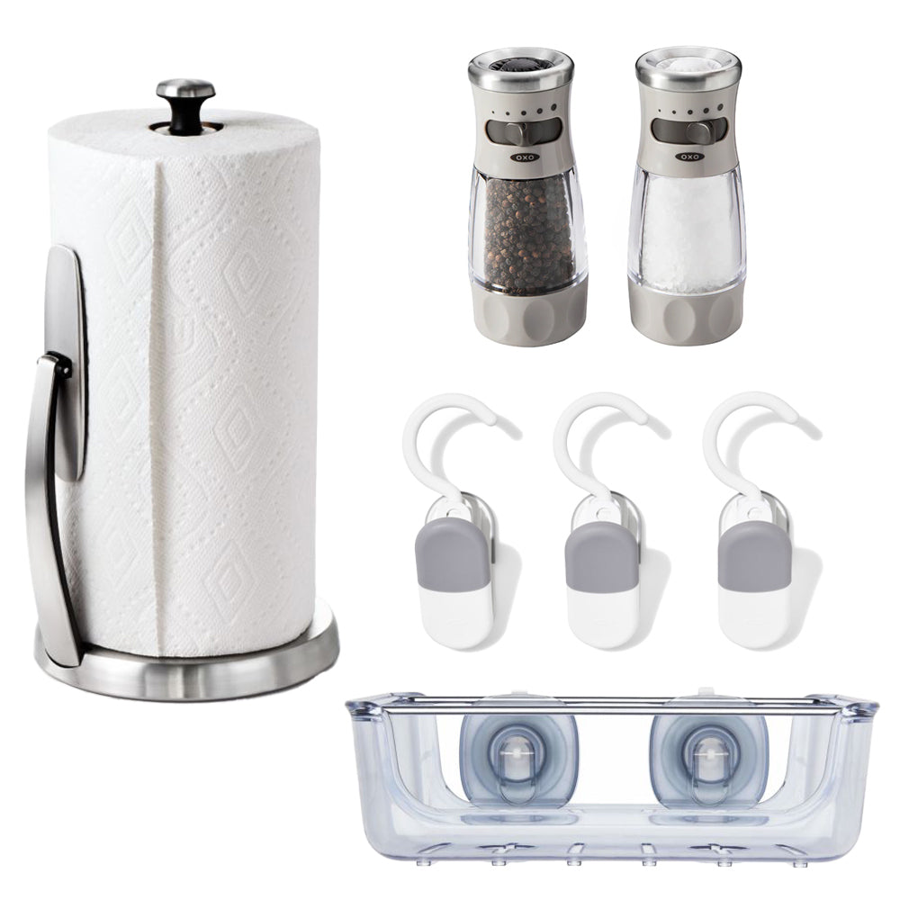 The Kitchen Organization Bundle by OXO includes a paper towel roll with stand, salt and pepper grinders, three white and gray bag clips with hooks, and a clear plastic container with two suction cups—making it ideal for efficient kitchen organization at home or in an Airstream galley.