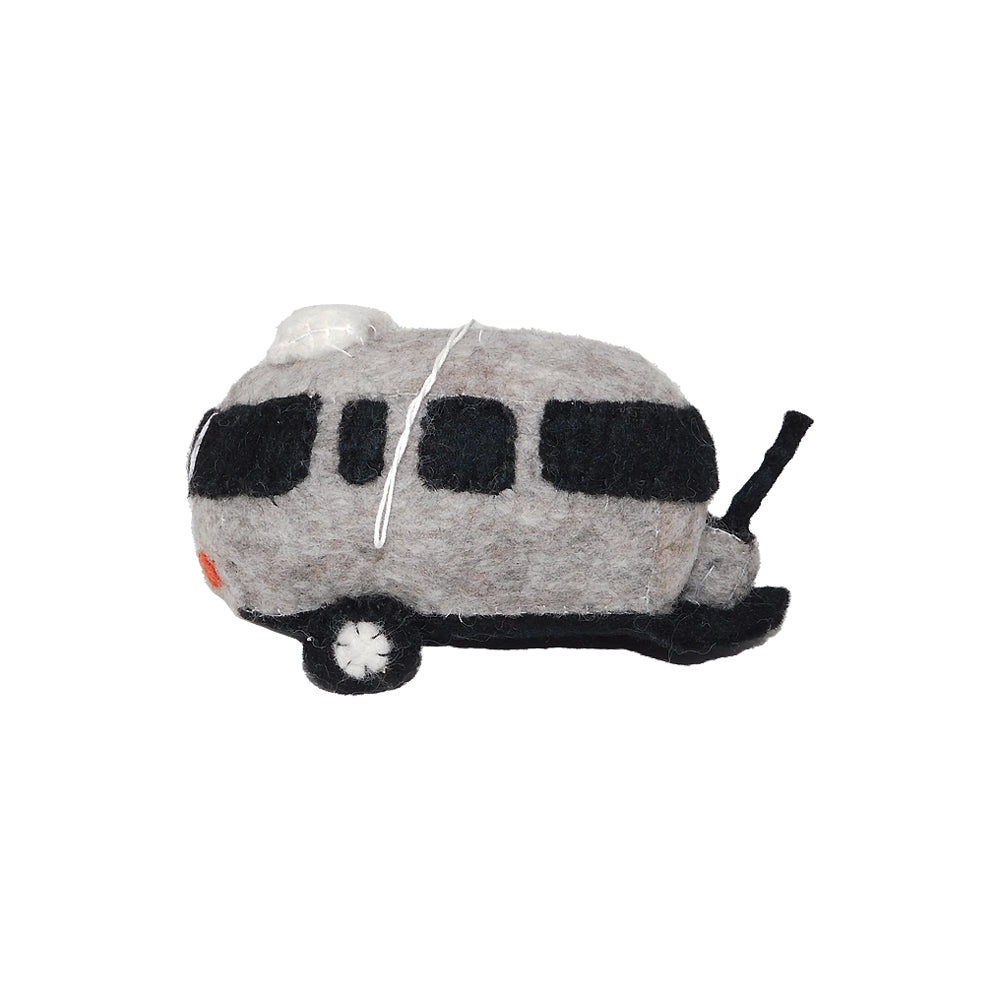 The Airstream Plush Trailer Ornament—a small, handmade felted wool decoration in the shape of a silver and black travel trailer with detailed windows and a hitch—is pictured in profile on a white background, offering an eco-friendly holiday accent for your tree.