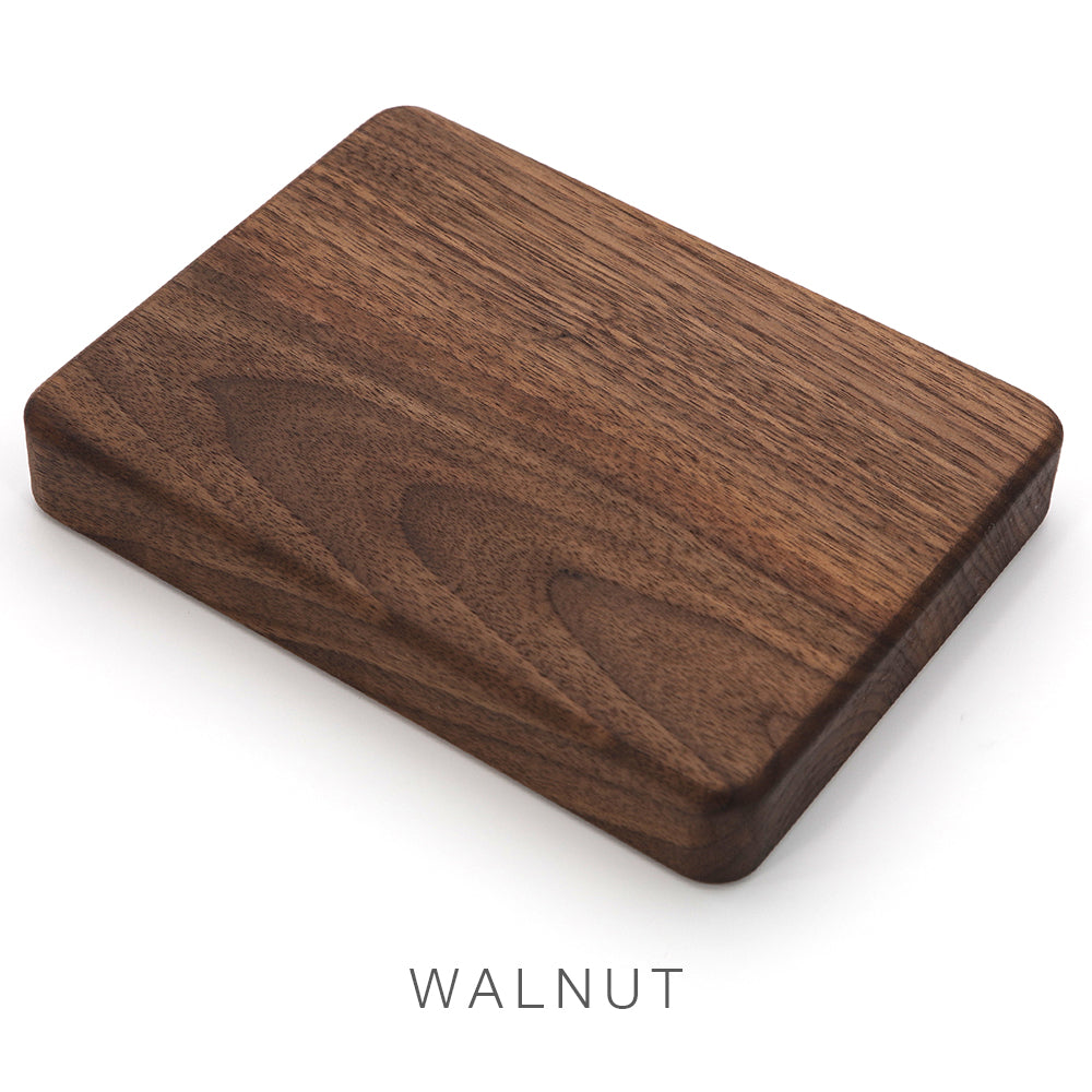 A solid rectangular walnut block with smooth edges sits on a white background. Below the block, “Airstream Wood Dinette Table Upgrade for International Travel Trailers” is written in uppercase letters, highlighting its resemblance to a premium wood tabletop.
