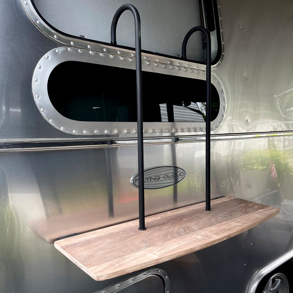 wooden shelf hanging off Airstream