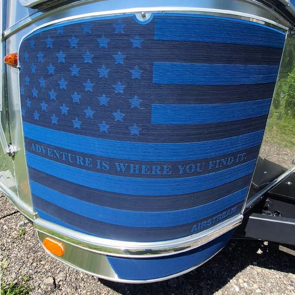 Blue American flag design on a vehicle with 'Adventure is Where You Find It' text, featuring the Airstream brand.