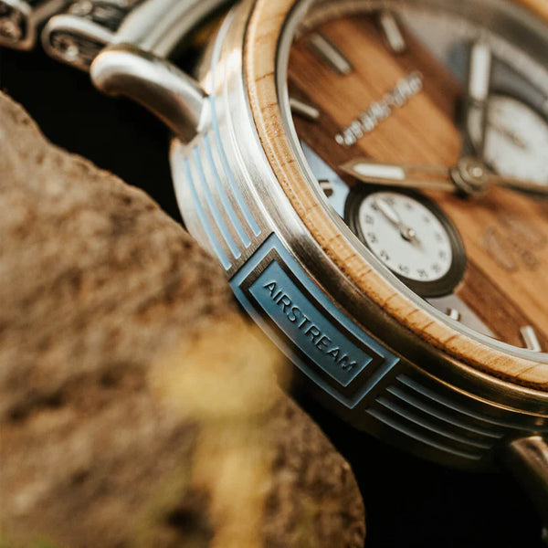 Wooden watch with 'Airstream' branding on a natural background