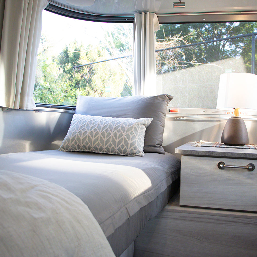 One of the twin beds in an Airstream Travel Trailer with Beddy's zip sheets and pillows