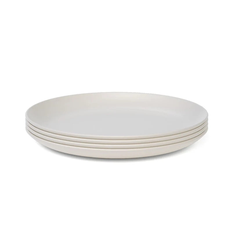 A set of four plain, round, white Bamboo Round Plates by Ekobo, made from BPA-free bamboo eco-composite, is displayed against a white background.