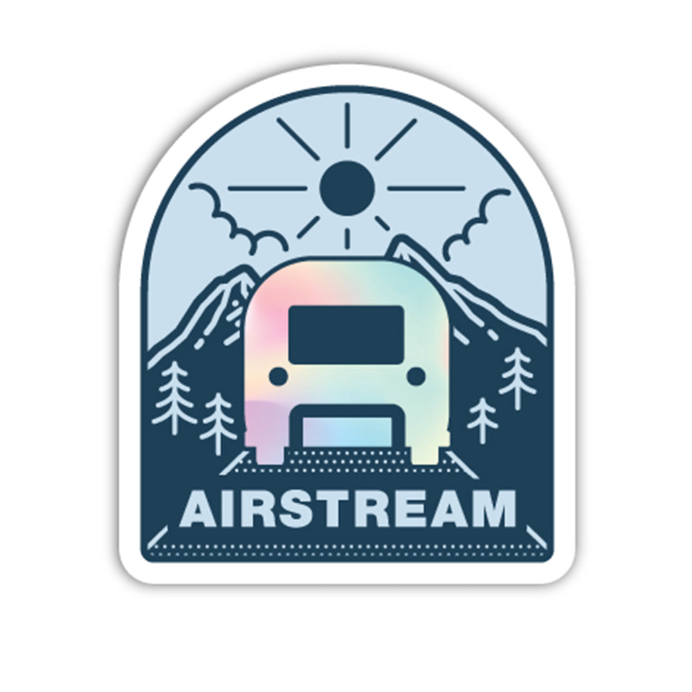 Introducing the Airstream Travel Trailer Mountains Holographic Stickers—featuring an iconic aluminum travel trailer illustrated with a pastel gradient, set against a scenic backdrop of mountains, trees, sun, and clouds. Below the trailer, bold lettering spells out “AIRSTREAM,” making this one of the must-have holographic stickers for fans of Airstream and eye-catching design.