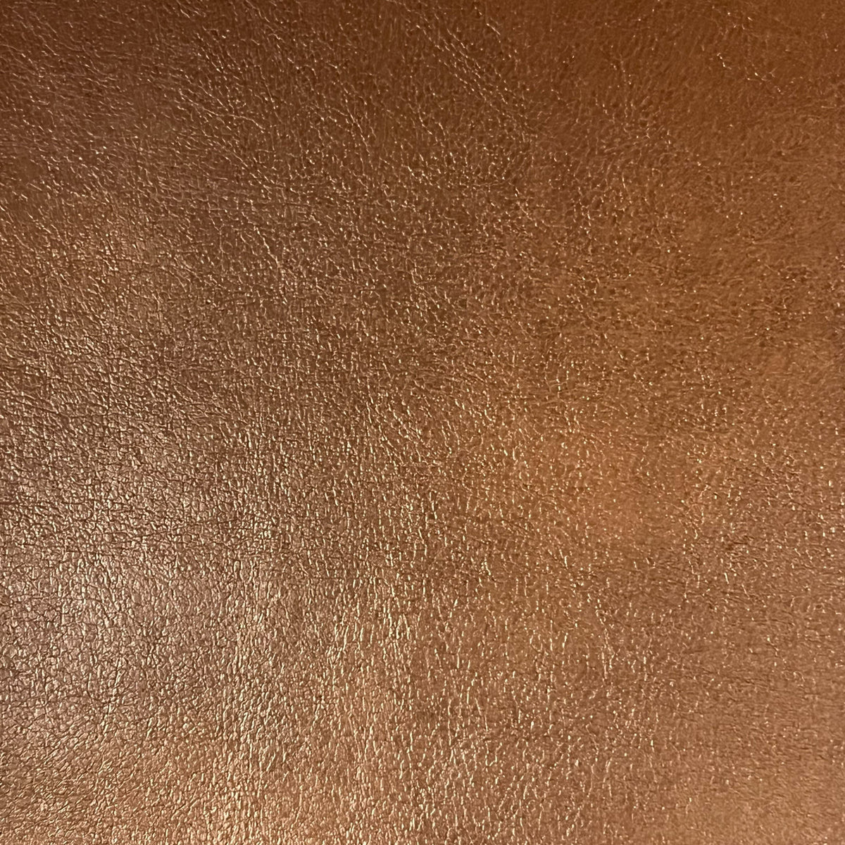 Close-up of a brown leather texture with visible grain and natural creases, offering a slightly glossy and uneven surface—ideal for Airstream Custom Replacement Cushion Covers for Basecamp 20 Travel Trailers that blend durability with timeless style.