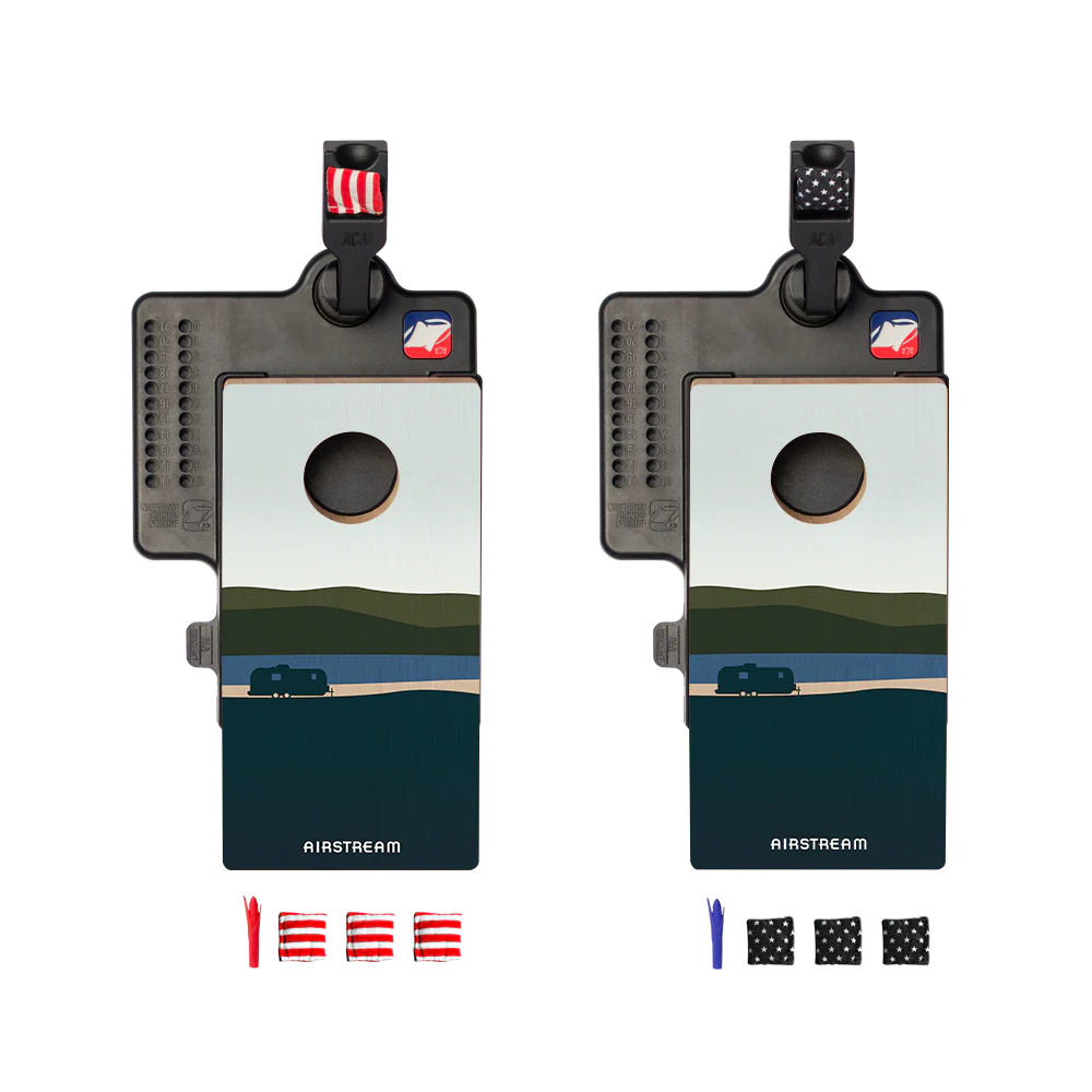 Bring the fun of cornhole anywhere with the Airstream ACA Double Chuck Mini Cornhole Tabletop Game, featuring two portable boards with a scenic RV landscape design. Each mini set comes with its own colored bean bags (red/white and black/blue) and attached carabiners displaying a flag or logo, making this the ultimate portable cornhole game for on-the-go entertainment.