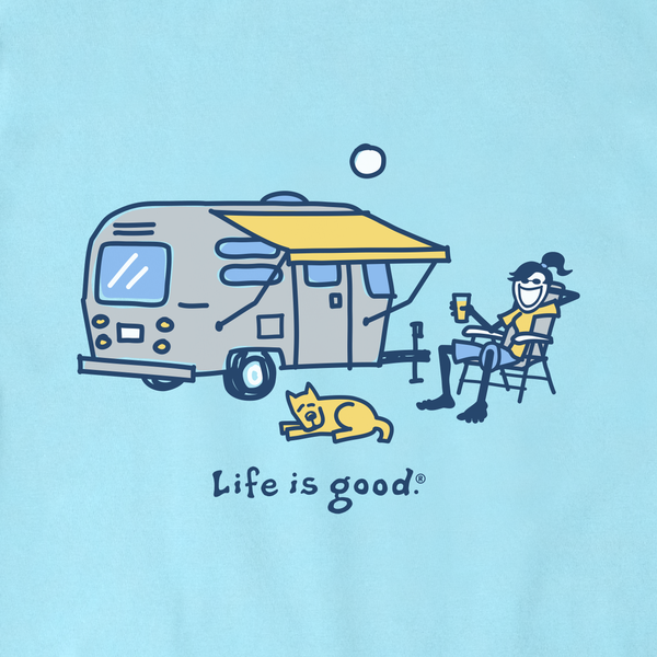 A light blue graphic print featuring a retro camping trailer with a yellow awning, a person sitting in a chair holding a drink, a yellow cat lying on the ground, and the text 'Life is good.'.