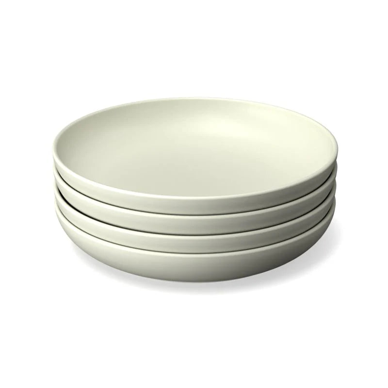 A stack of four sustainable, white Bamboo Round Plates by Ekobo is shown against a white background—an ideal set for those seeking reusable products to elevate their dining experience.