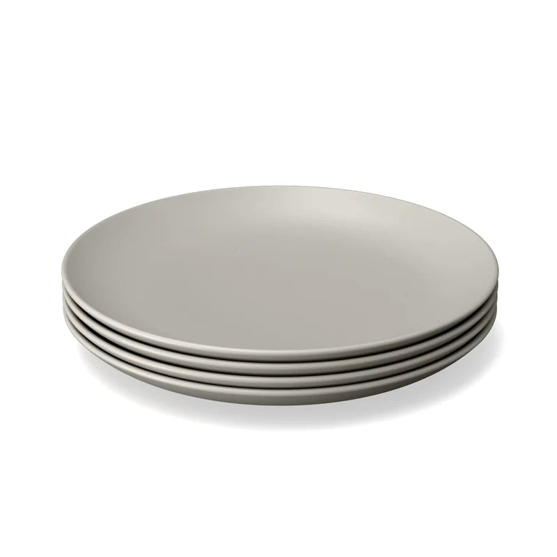 A stack of four plain, light gray Bamboo Round Plates by Ekobo is shown on a white background—an ideal choice for those seeking reusable products that blend style and sustainability.