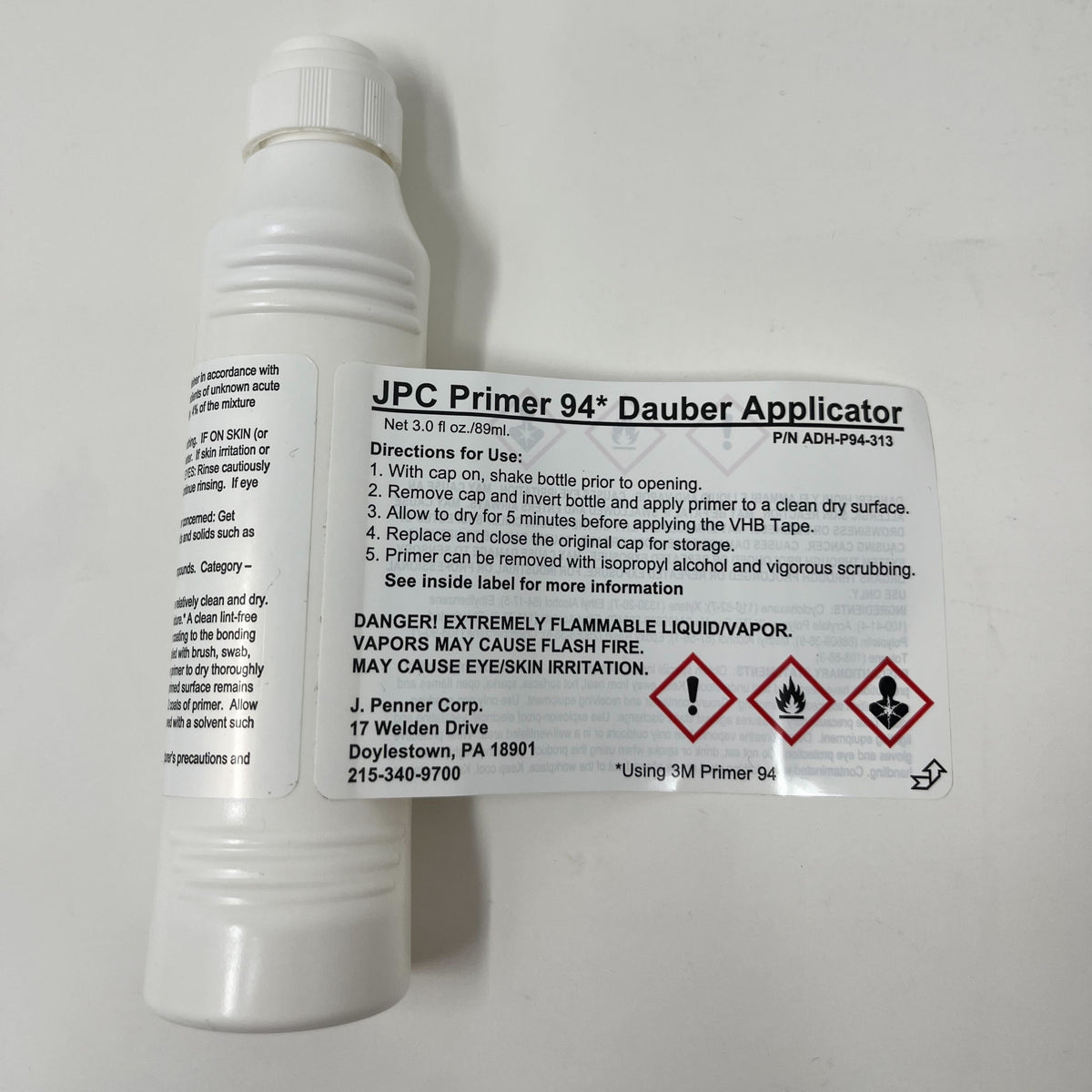 White bottle labeled Airstream 3M Adhesive Primer for Replacement Trim with usage directions, hazard symbols, and safety warnings. Includes contact information and instructions for applying the adhesive primer to surfaces before using VHB Tape—ideal for trim replacement or as a rub rail sealant.