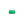 Green automotive fuse on a white background