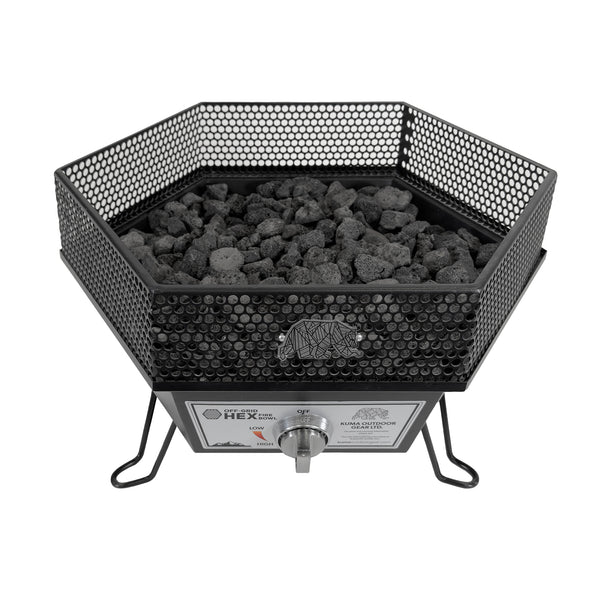 Hexagonal metal fire pit with charcoal inside on a white background