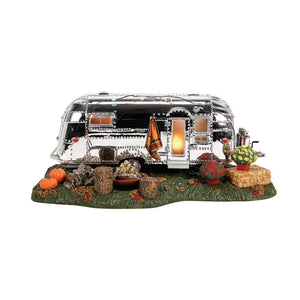 Model of a vintage camper with decorative elements on a white background