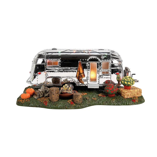Model of a vintage camper with decorative elements on a white background