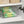 Clear storage bin with snacks inside a cabinet