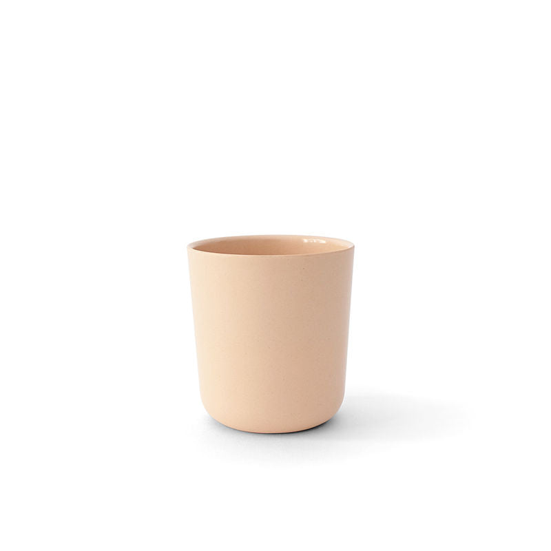 A set of Ekobo Bamboo Cups, 12 oz each, in a plain light beige tone with smooth surfaces, rests on a white background and casts a faint shadow to the right—showcasing the elegance and sustainability of these everyday dining essentials.