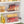 Clear storage bins organizing snacks and pantry items in a kitchen cabinet.