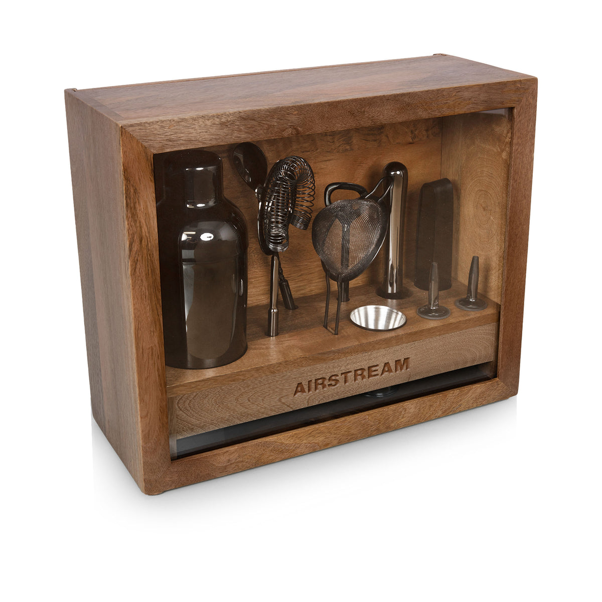 The Airstream Old Fashioned Bar Set features black bar tools—including a shaker, strainer, jigger, and pourers—beautifully displayed in a wooden box with a glass front and “AIRSTREAM” engraved at the bottom, making it perfect for the eco-conscious bartender.