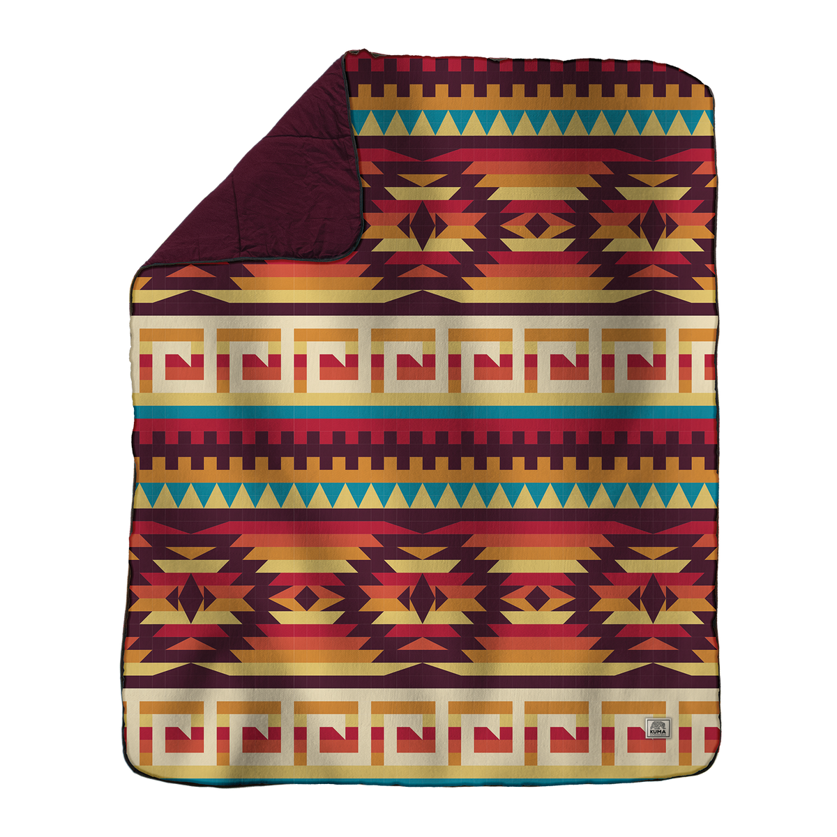 The Kamp Blanket by KUMA Outdoor Gear is a rectangular camping blanket adorned with vibrant geometric patterns in red, gold, green, and teal—featuring stripes, triangles, and squares. Made from durable polyester material for lasting use both outdoors and indoors, it has a folded corner that reveals a maroon underside.