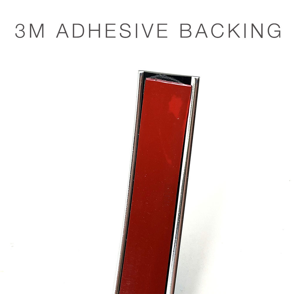 A close-up of the Airstream Premium Replacement Rub Rail for Travel Trailers, a rectangular object featuring a partially peeled red 3M adhesive backing. The text “3M ADHESIVE BACKING” appears at the top of the image, highlighting its application as an ideal rub rail replacement for riveted aluminum Airstream trailers.