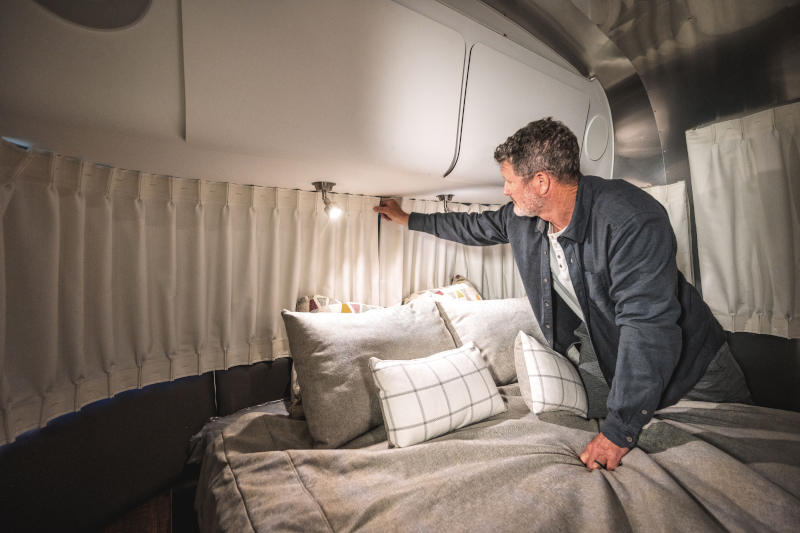 Man closing custom made Airstream curtains