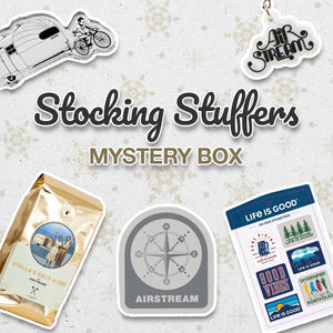 A collage showing Airstream-themed stickers, coffee bag, and patch, with the words Stocking Stuffers Mystery Box on a snowflake background.