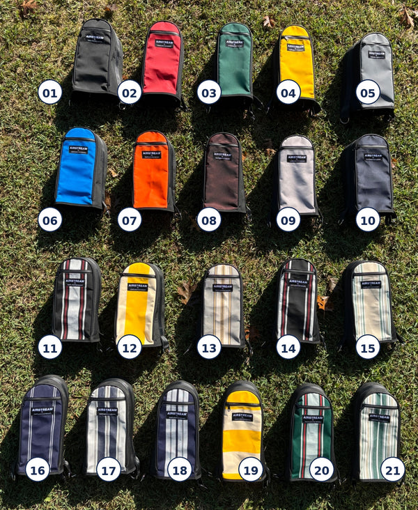 Twenty-one Airstream Water Resistant Jack Covers in various solid colors and striped patterns, arranged in a grid on a grassy lawn and numbered 01 through 21.
