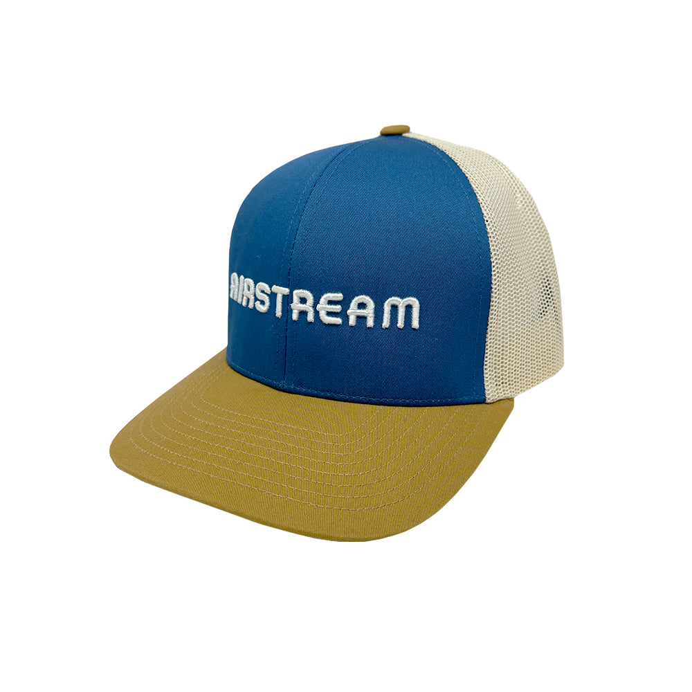 The Airstream 3D Art Deco Trucker Hat features a blue and tan vintage design with a beige mesh back and “AIRSTREAM” embroidered in white on the front, offering classic retro style for any adventure.