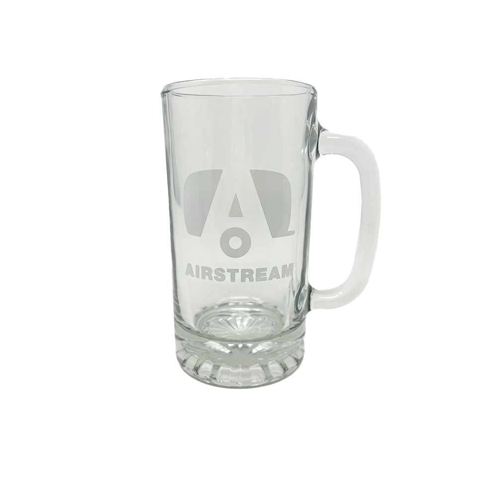 An empty Airstream Beer Stein, made of clear glass with a large handle, displays the Airstream logo and the word “AIRSTREAM” etched on its front. The classic stein is set against a plain white background.